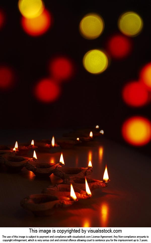 Happy Diwali Many Terracotta diya Oil-lamps Arranged on-Black background