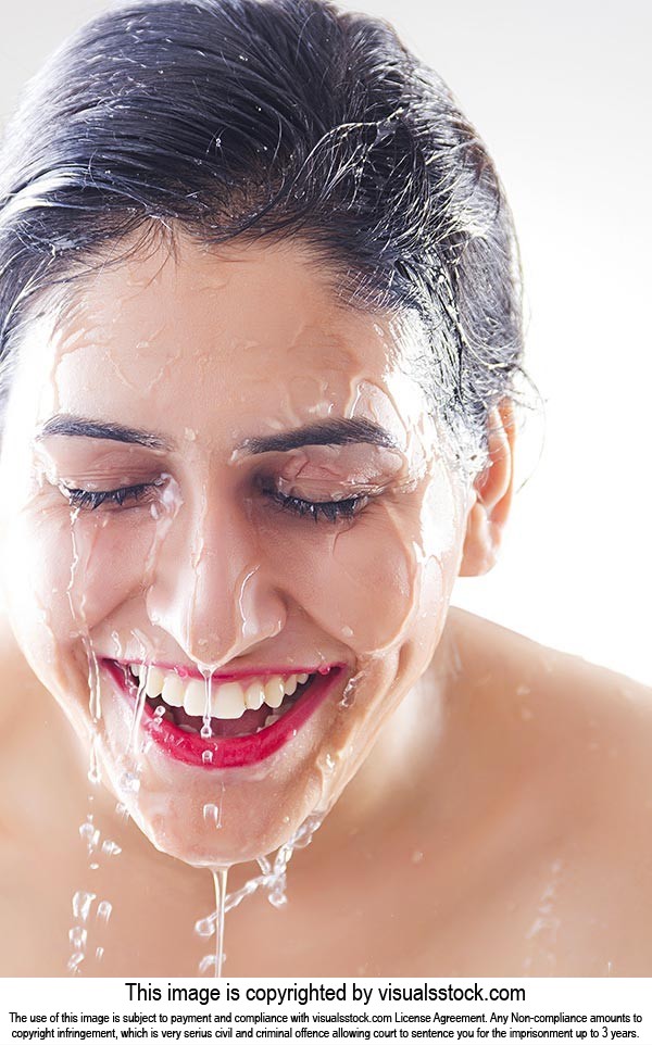 Beautiful woman washing Cleaning face water Smilin