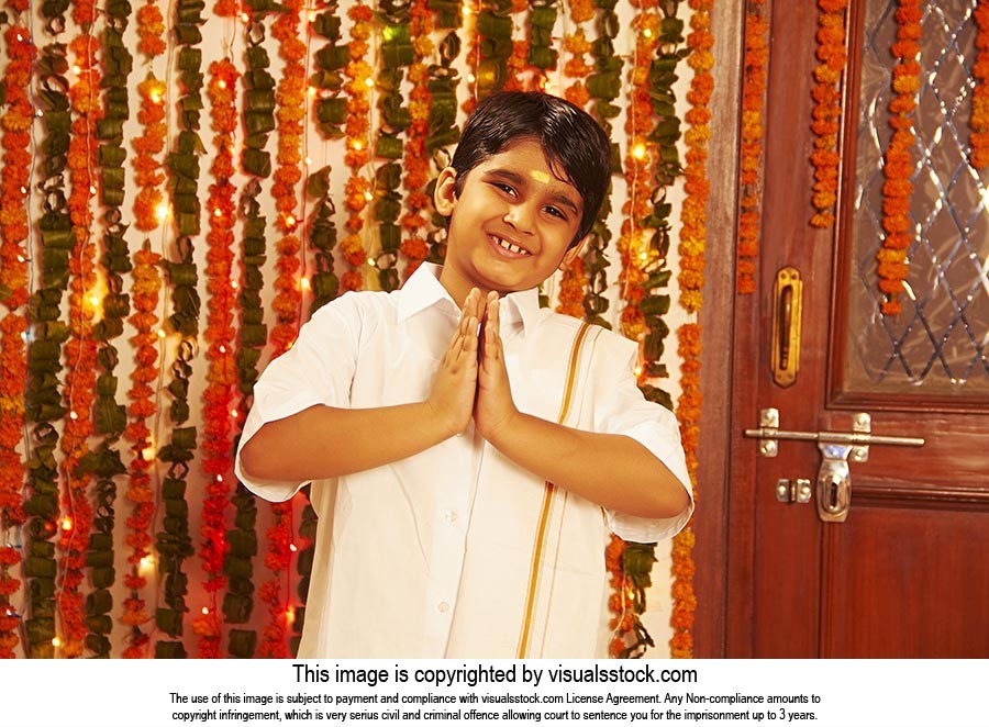 little Boy Greeting in traditional South Indian dress on Onam Festival