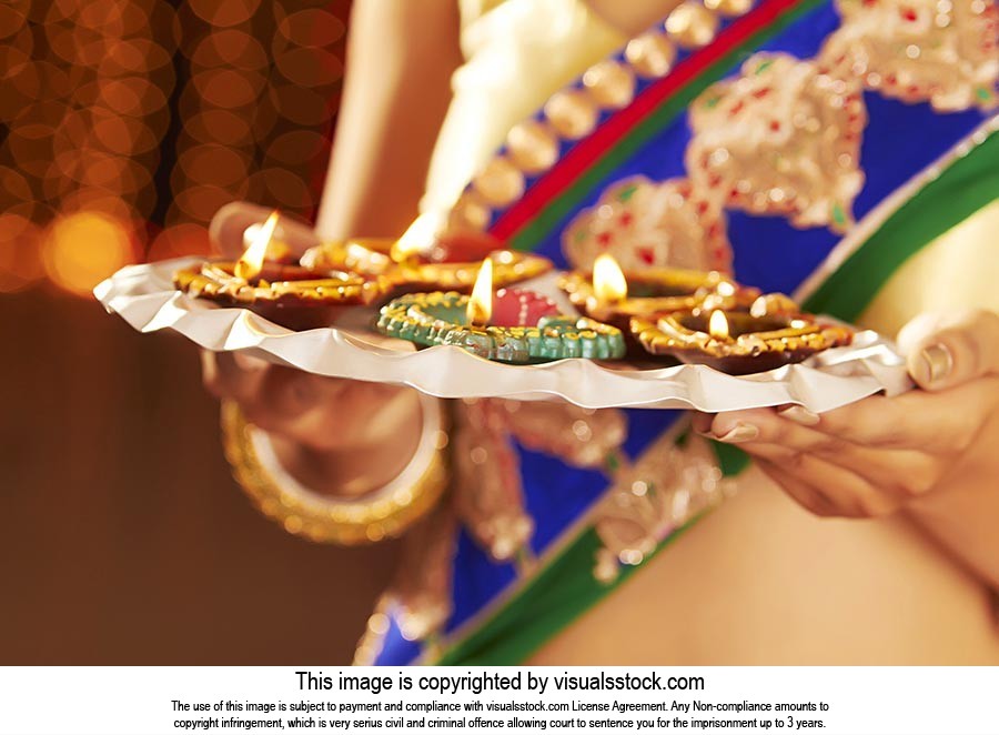Woman Lighting Diyas Diwali