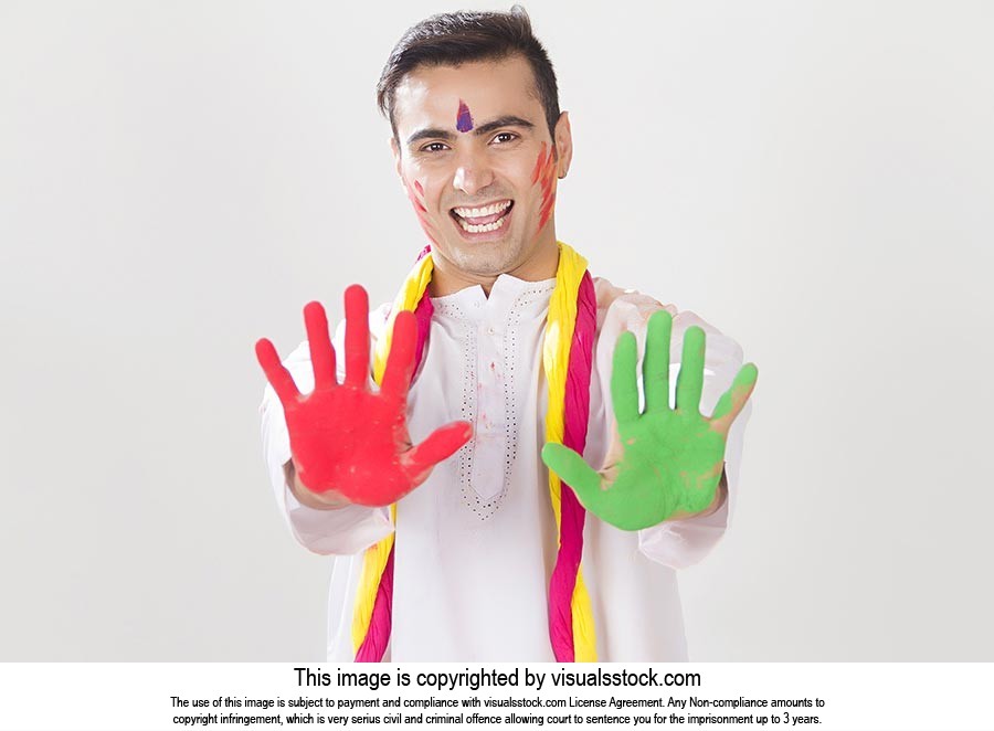 Excited man showing colored hands Holi Celebration