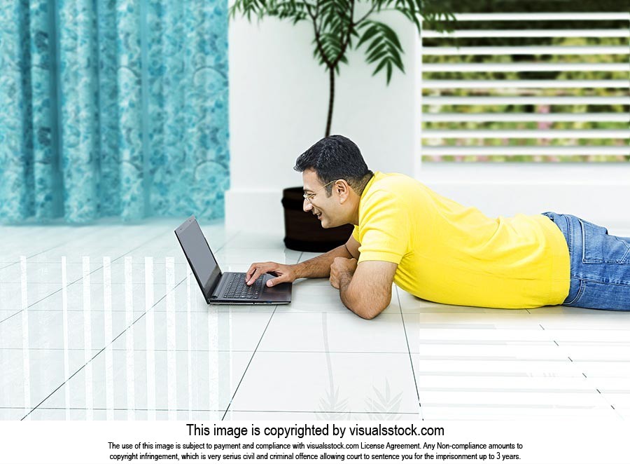 Man Using Laptop Lying Floor