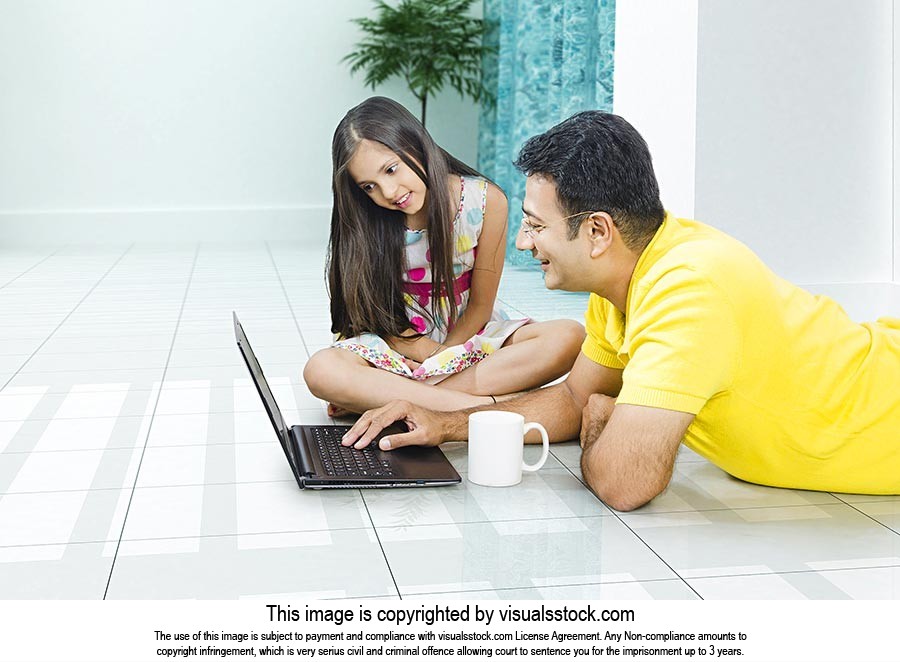 Father Daughter Using Laptop At Home