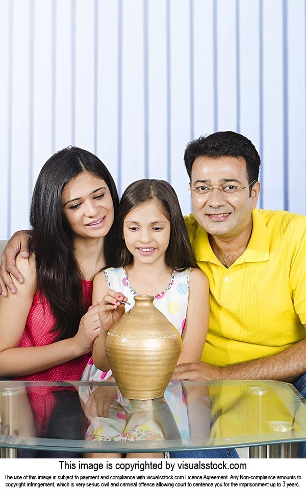 Indian Family Putting Coin Piggybank