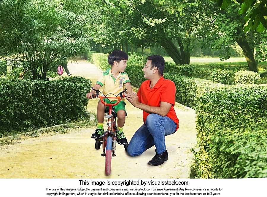 Father Teaches Son Ride Bike Park