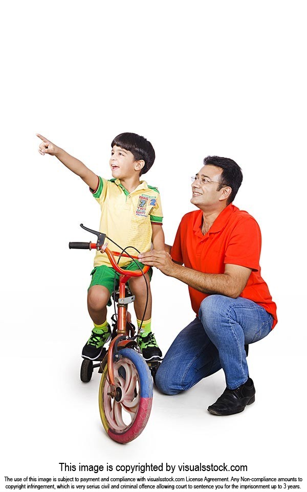 Father Teaching Son Ride Bicycle Pointing