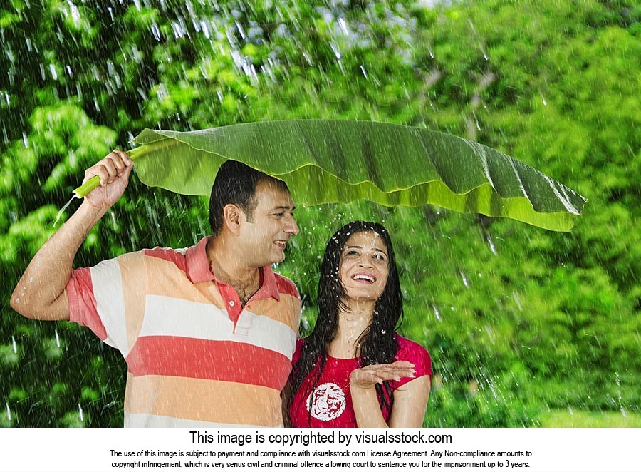 Indian Couple Enjoying Rain Park