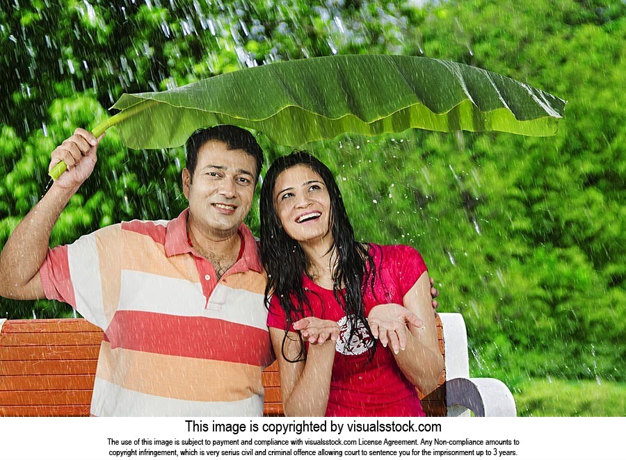 Couple Enjoy Rain Under Banana Leaf