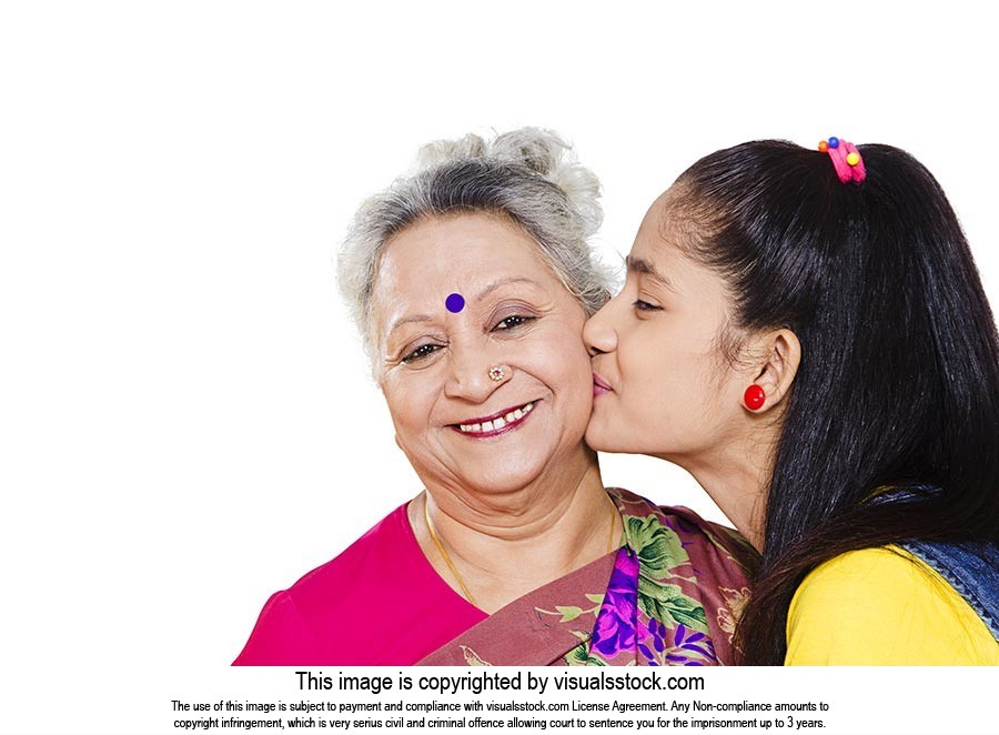 Granddaughter kissing Grandmother Cheek