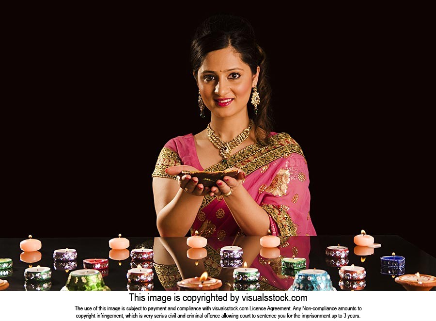 Indian Woman Lighting Diya Celebrating Diwali