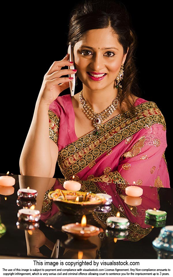 Woman Diyas Stack Talking phone Diwali