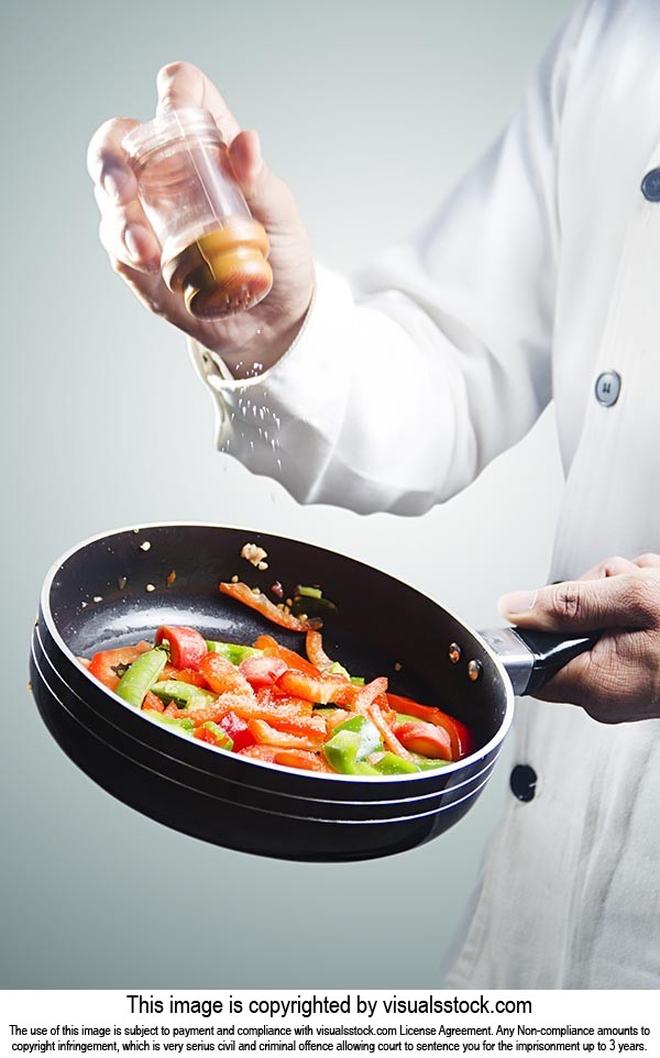 Chef Cook Pouring Salt Cooking Vegetable