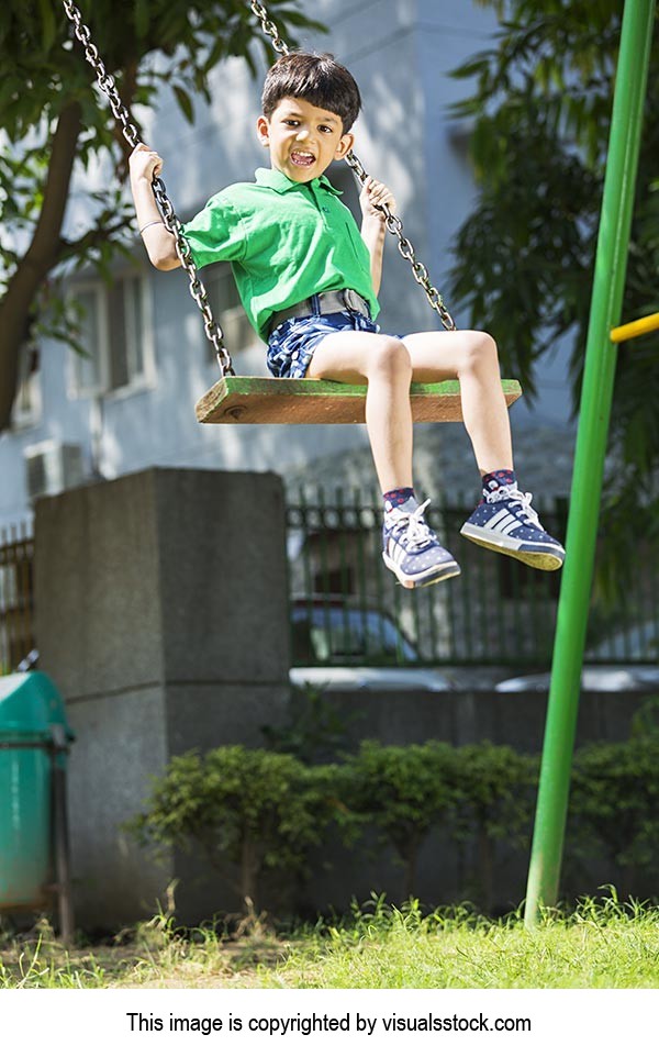 Happy Little Boy Swinging on swing Jhula Fun Enjoying at park