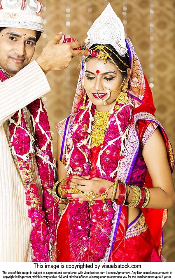 Bengali groom putting sindoor on brides forehead Hindu Wedding Ritual