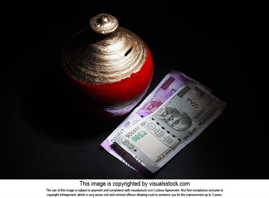 Clay Piggy Bank with indian currency on-black background Saving-Money  Concept