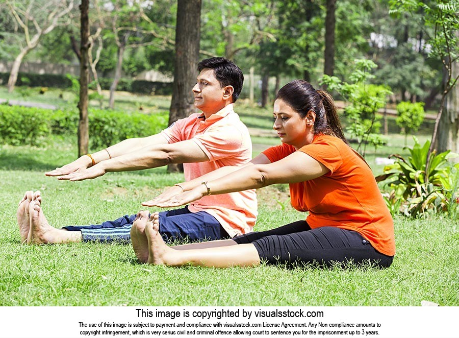 Indian Couple Sitting Grass Yoga Stretching Exercise Work-Out Park