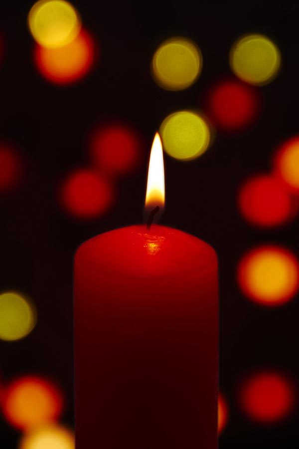 Closeup-of iIlluminated Burning candle Candlelight on-black Background ...