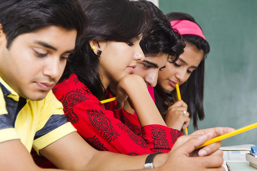 Four college Boys And girls students studying Book Preparing-Exam In ...