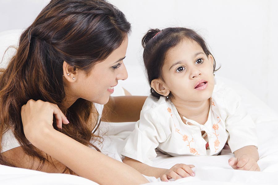 Indian Mother and Child-Daughter relaxing on bed Love Caring