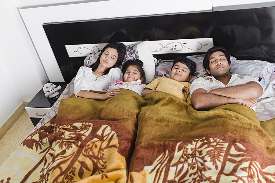 Happy Family Parents And Two Kids Sleeping Together On Bed Bedroom At Home   AK21550 