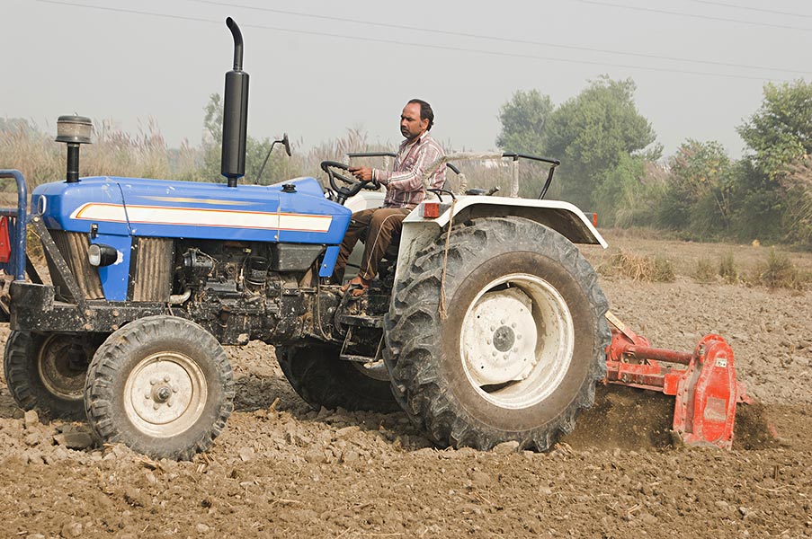 Indian Rural Farmer Man Driving Tractor Farm Working