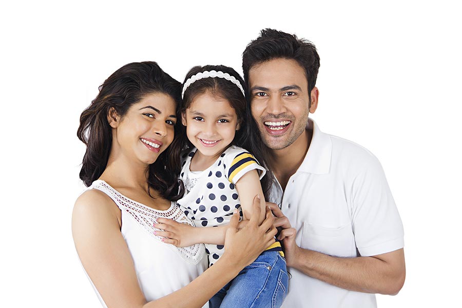 Happy Family Parents and Little-Daughter Standing Together And Smiling