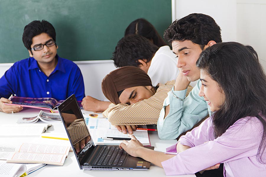 Group Young College Students Studying Book And Boy Sleeping in-Classroom