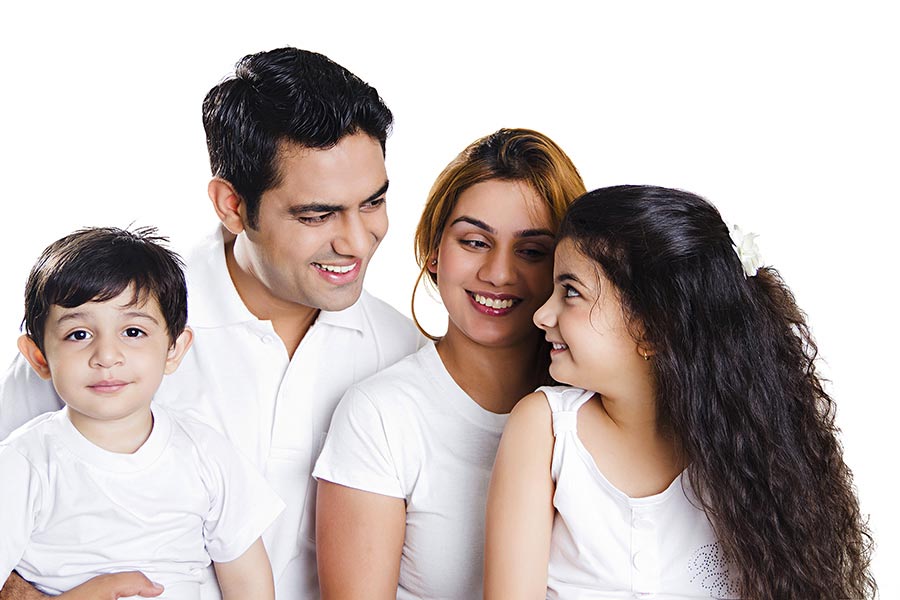 Indian Family Parents And Children Sitting Together On White background