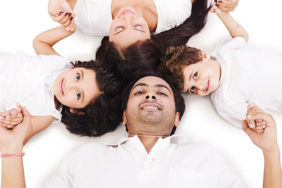 Top-View Happy Family Parents And Two-Childen Lying-on-Floor Holding ...