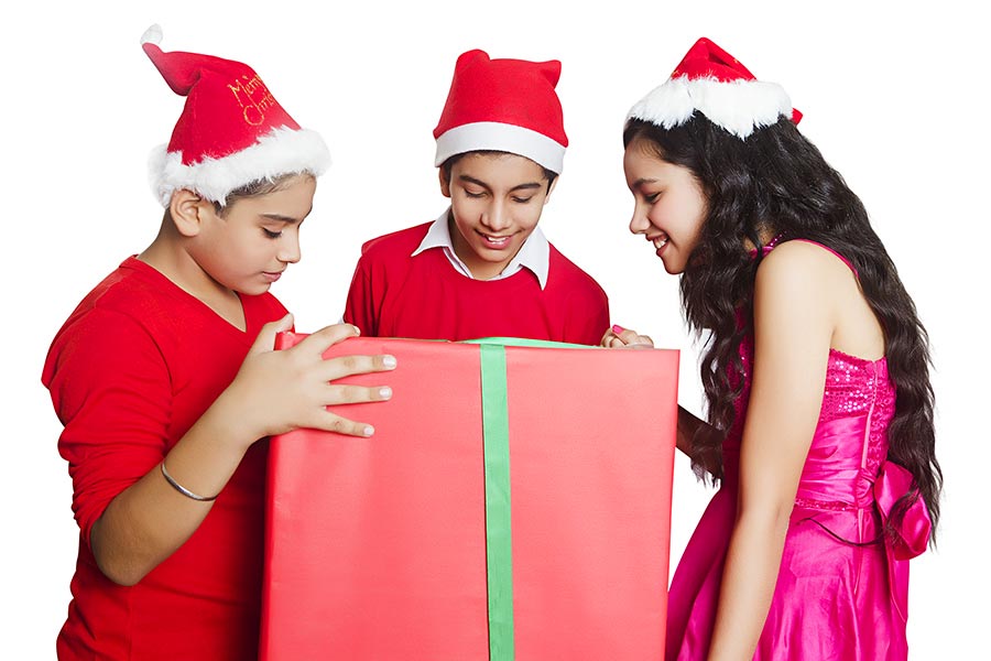 Three Young Teenagers Friends Holding Big Gift Box on-Christmas Celebration