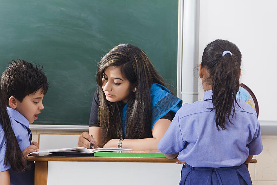 School Teacher teaching her Kids-students Reading Book Studying ...