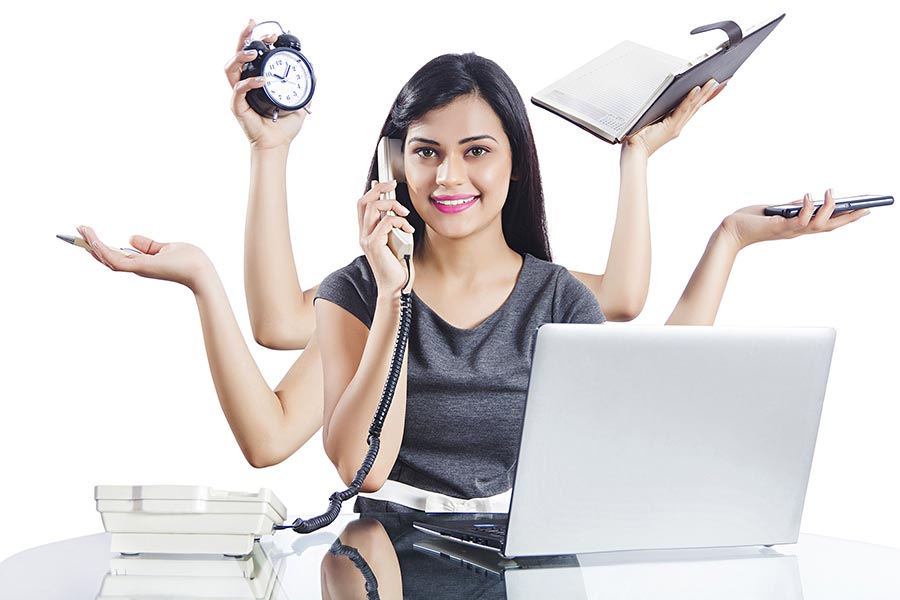 Indian Businesswoman to do a multi-tasking At Desk In Office