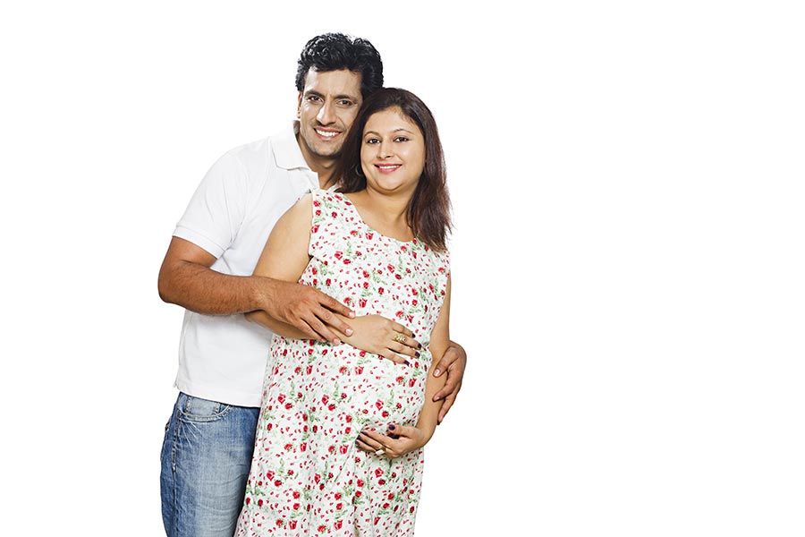 Indian Pregnant Woman Touching Her Belly With Her Husband New Beginning
