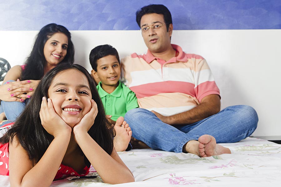 Indian Family Kid Girl Lying Bed Relaxing Bedroom At Home