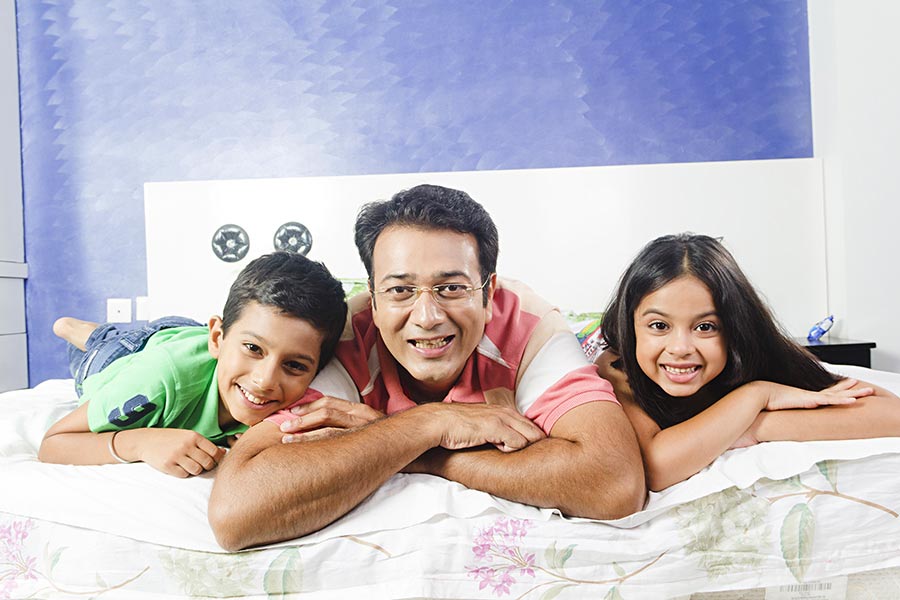 Indian Father And Kids Son, Daughter Lying Bed Together Bedroom