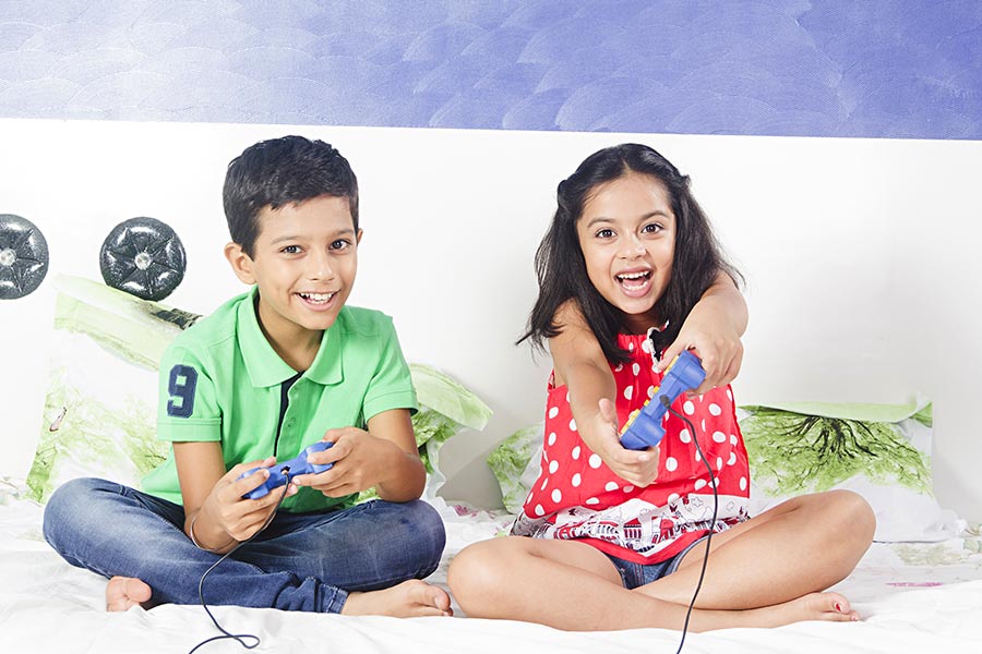 Indian Kids Brother Sister Playing Video Game Fun In Bedroom