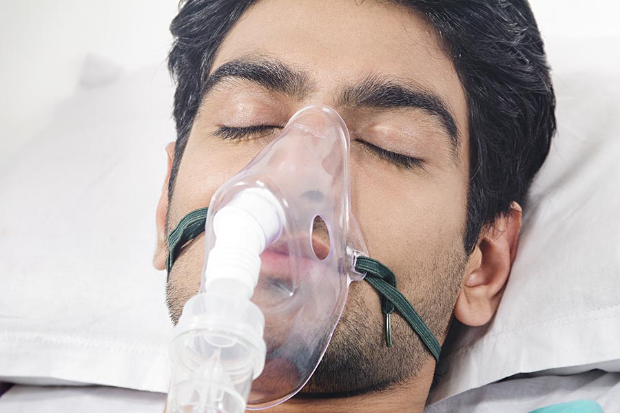 closeup man patient wearing oxygen mask in-Hospital bed Medical Treatment