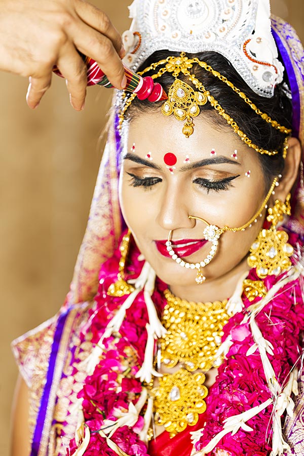 Groom Putting Sindoor On-Bride Forehead In-Indian Hindu Wedding Ceremony