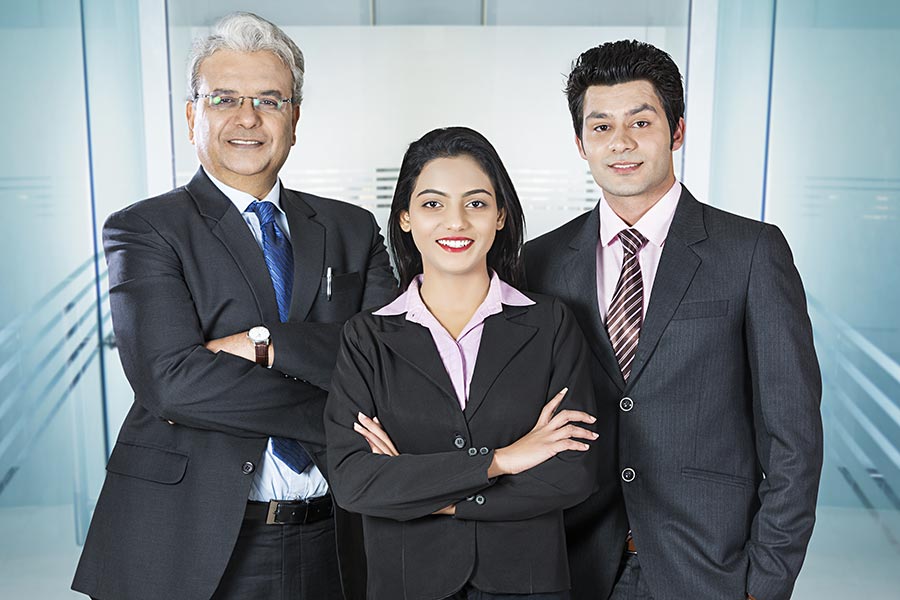 Indian Businessmen And Businesswoman Patners Arms Crossed Standing Office