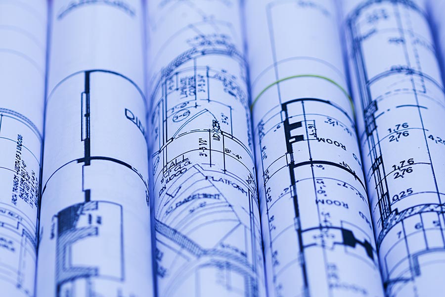 architectural-for-construction-drawings-with-roll-of-blueprints-real