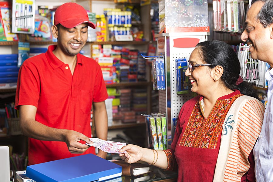 indian-shopkeeper-receiving-rupees-notes-customer-product-bill-pay-shop