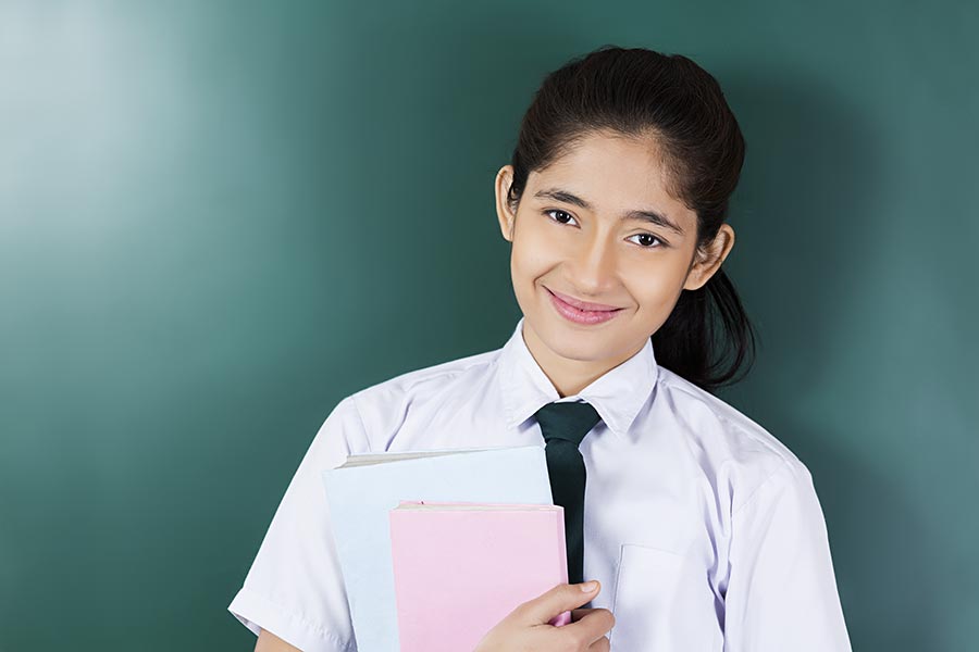 Smiling Indian High School Girl Student Holding Book Blackboard Classroom