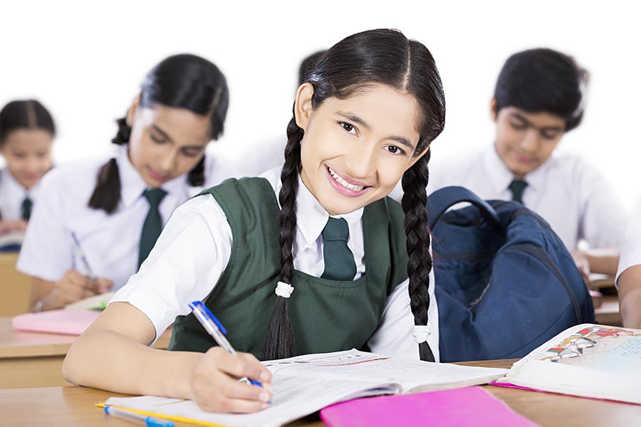 Indian School Teenage-Girl Student Writing In-Notebook Studying In