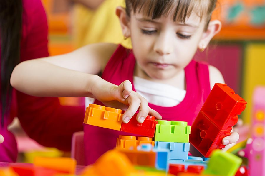 Close-up Play school Kid-Girl Student With Teacher Playing Toy-Blocks ...