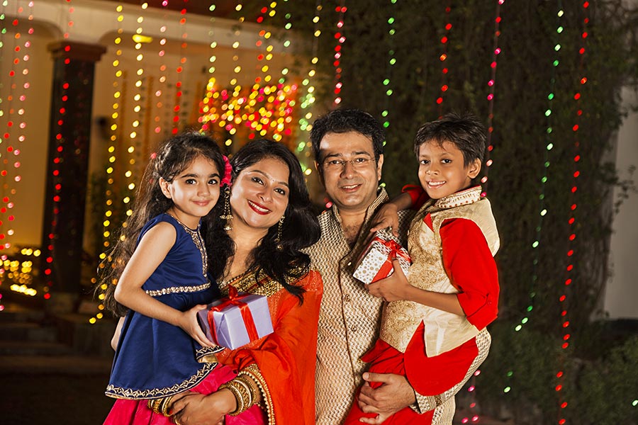 Indian Family Parents And Kids Holding Gift-Box Duing Diwali festival ...