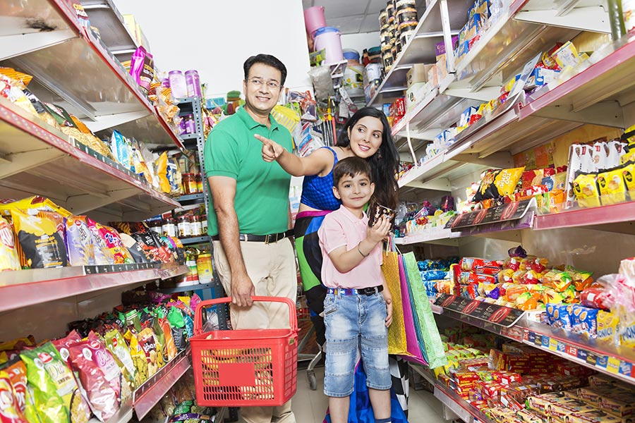 Indian Family Parents And Little-Son Doing Shopping Pointing-At ...