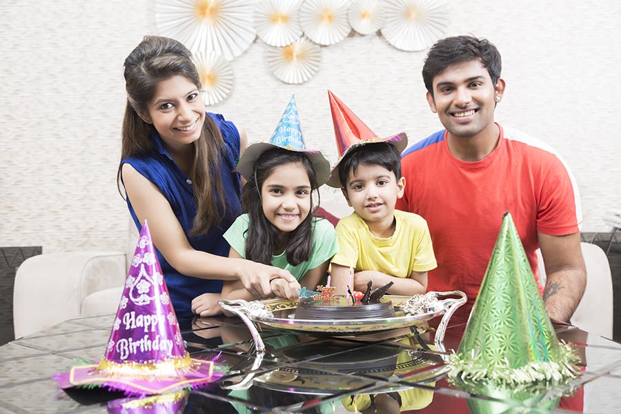 happy-family-parents-and-kids-celebrating-birthday-party-at-home