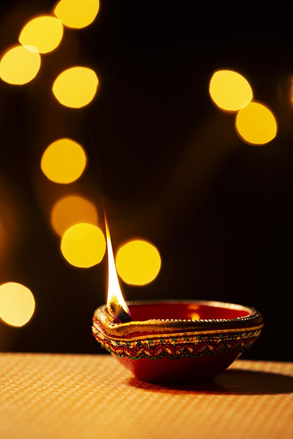 Traditional clay diya lamps lit during Deepavali Festival celebration ...