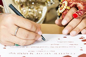 Groom Signing Marriage Certificate